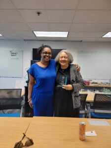 Two women standing next to each other in a room.