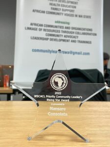 A glass award sitting on top of a wooden table.