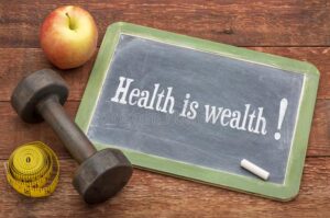 A chalkboard with the words health is wealth written on it.